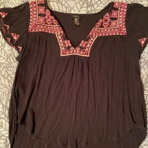 This is a black crop-top with a v-neck